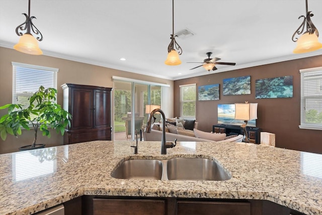 kitchen featuring a wealth of natural light and hanging light fixtures