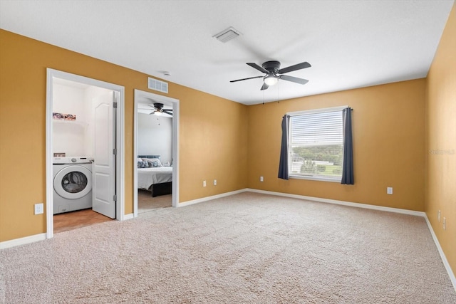 unfurnished bedroom with ensuite bath, ceiling fan, light colored carpet, and washer / clothes dryer