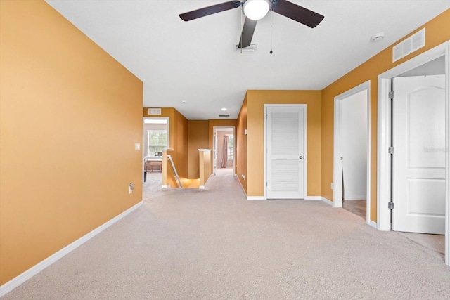 empty room featuring light carpet and ceiling fan