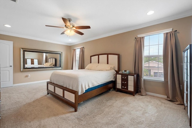 bedroom with ornamental molding, light colored carpet, and ceiling fan