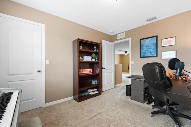 office space with light carpet and ceiling fan