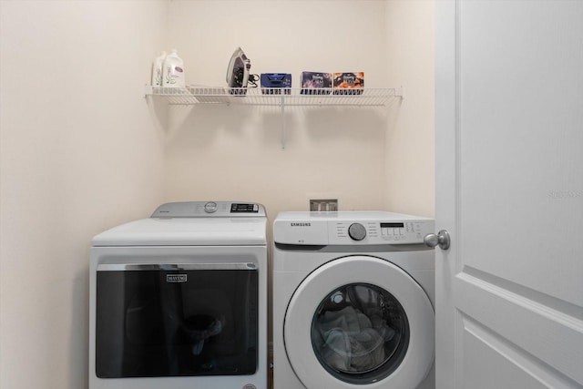 washroom with washing machine and clothes dryer