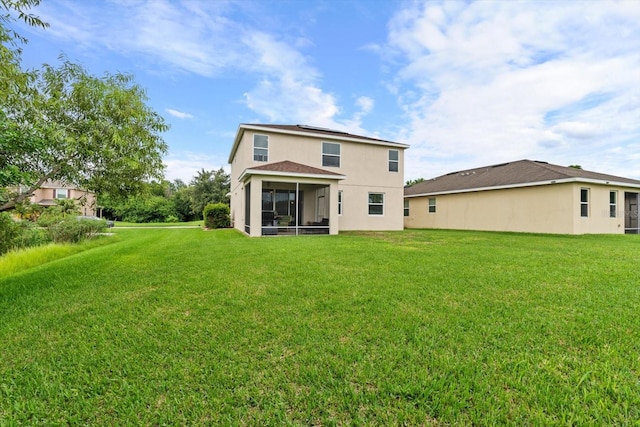 back of house with a sunroom and a lawn