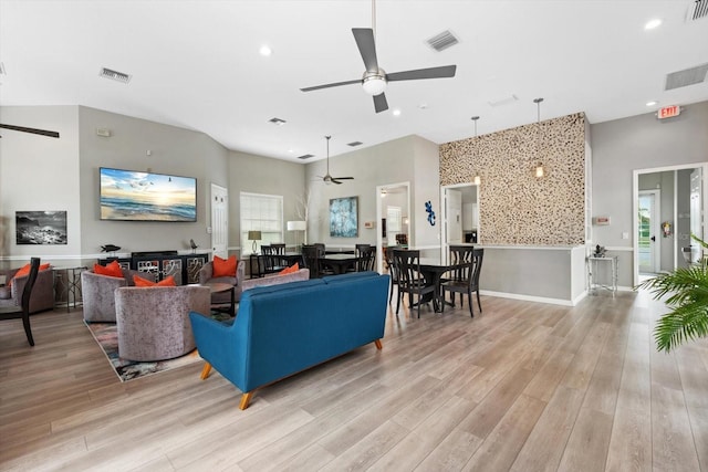 living room with light wood-type flooring and ceiling fan