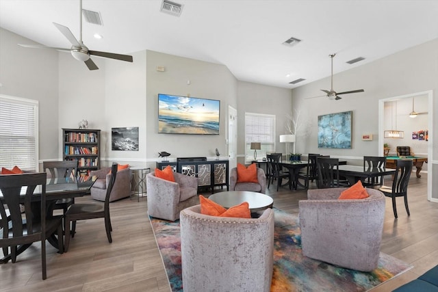 living room featuring hardwood / wood-style floors, a healthy amount of sunlight, and ceiling fan