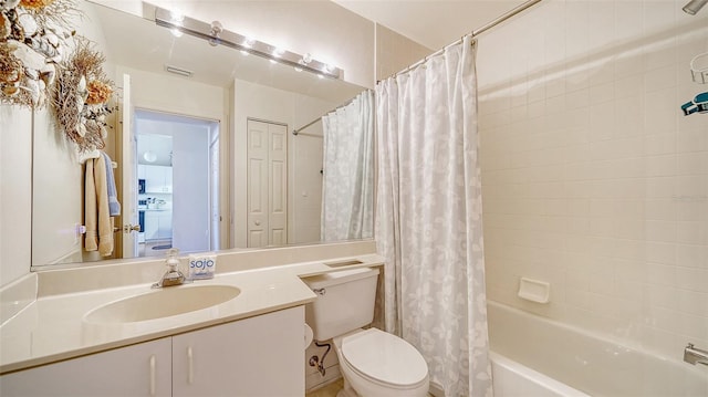 full bathroom featuring washer / dryer, vanity, toilet, and shower / bath combo with shower curtain