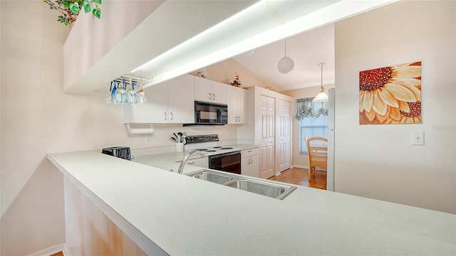 kitchen with white cabinets, hanging light fixtures, hardwood / wood-style flooring, sink, and white electric range oven