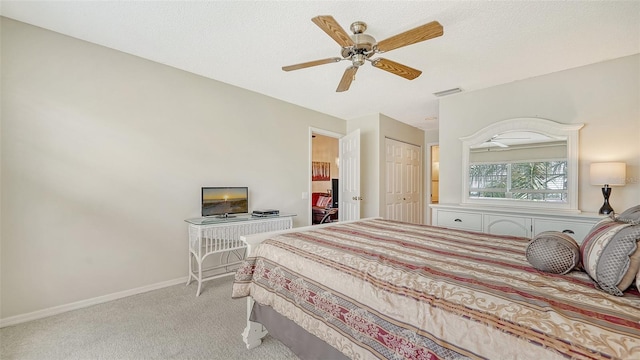 bedroom featuring a closet, ceiling fan, and light carpet