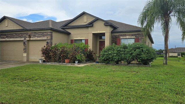 view of front of home with a garage and a front lawn