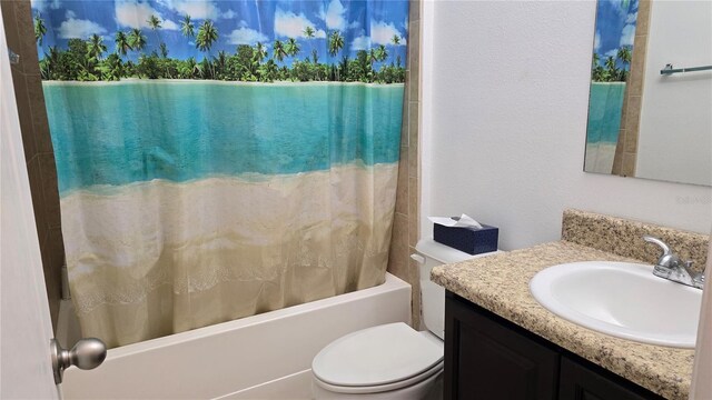 full bathroom featuring vanity, toilet, and shower / bath combination with curtain