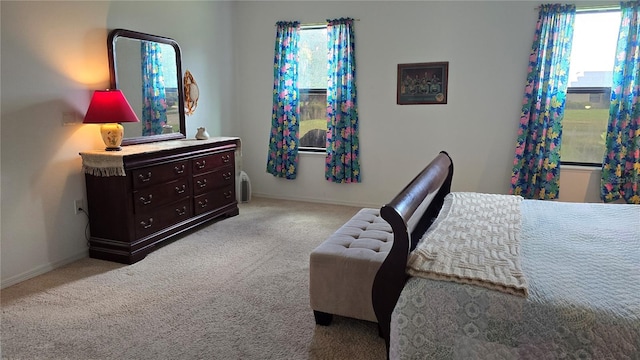 bedroom with light carpet and baseboards