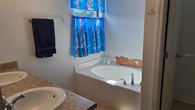 bathroom featuring a relaxing tiled tub and double vanity