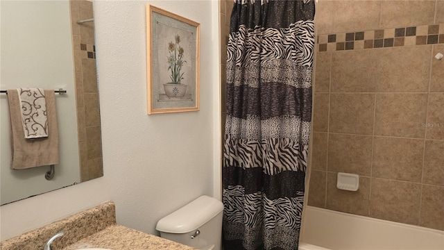 full bathroom with vanity, shower / bath combo, and toilet