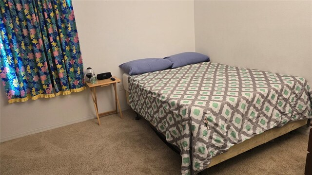 bedroom featuring carpet floors and baseboards