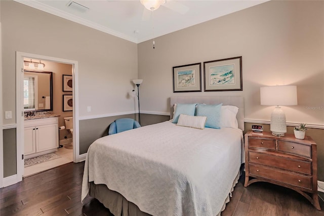 bedroom featuring ensuite bathroom, ceiling fan, dark hardwood / wood-style floors, and ornamental molding