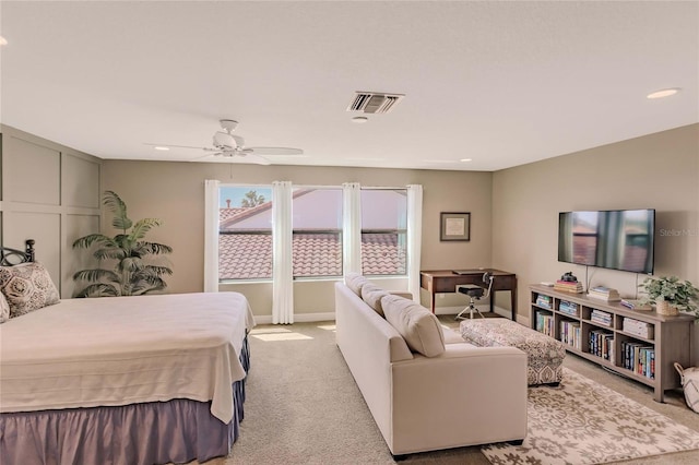 bedroom with ceiling fan and light colored carpet