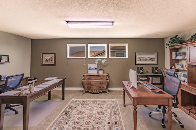 carpeted office featuring a textured ceiling