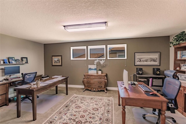 office area featuring light colored carpet and a textured ceiling