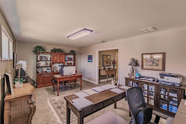 office featuring light colored carpet and a textured ceiling