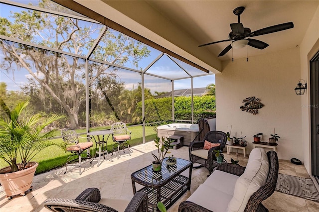 view of patio with outdoor lounge area, glass enclosure, a hot tub, and ceiling fan