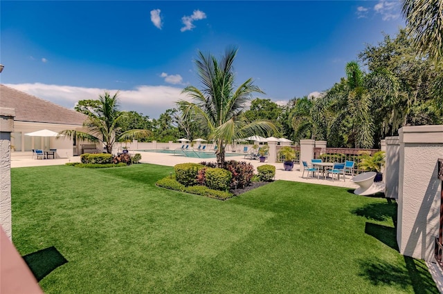 view of yard featuring a patio area and a community pool