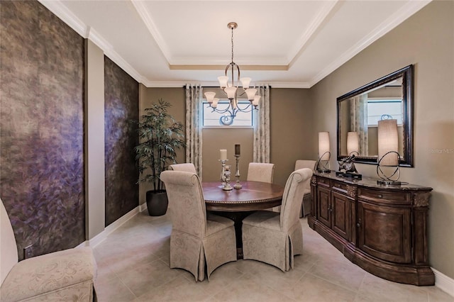 dining space featuring ornamental molding, a tray ceiling, plenty of natural light, and a notable chandelier