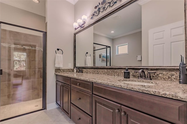 bathroom featuring tile patterned floors, crown molding, vanity, and a shower with shower door