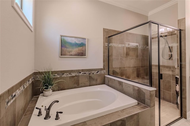 bathroom featuring ornamental molding and independent shower and bath