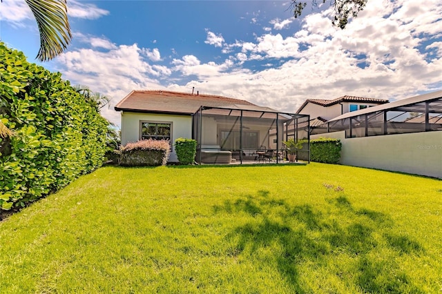 view of yard featuring glass enclosure and a patio area