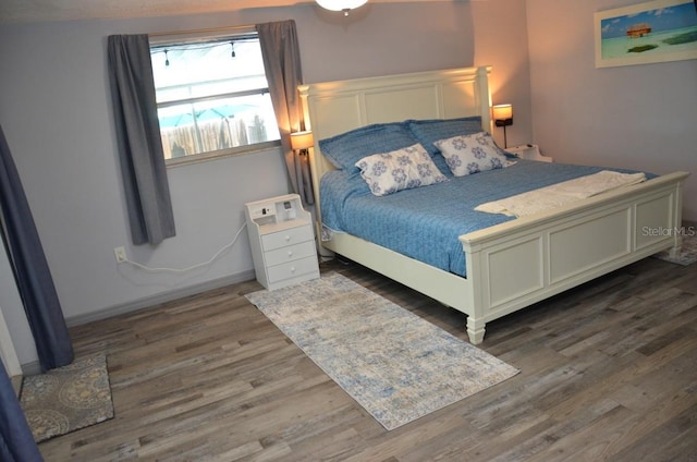 bedroom featuring dark hardwood / wood-style flooring