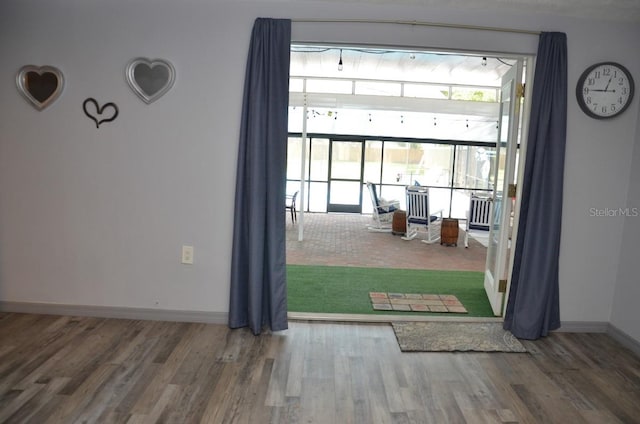 doorway to outside featuring a healthy amount of sunlight and hardwood / wood-style floors