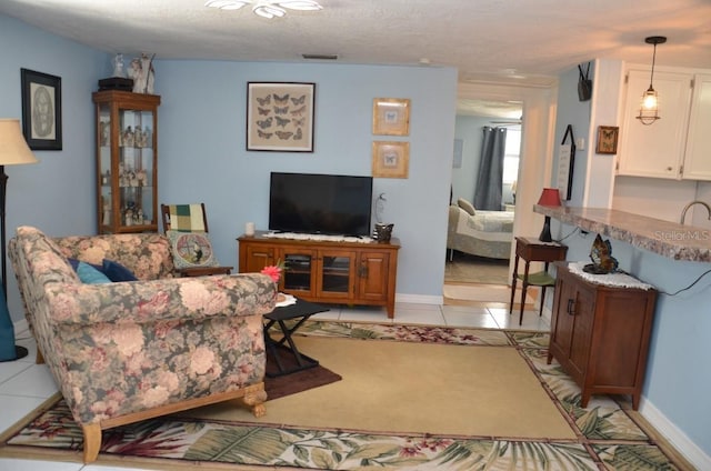 living room with light tile patterned floors and a textured ceiling