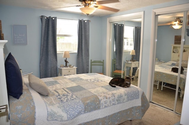 carpeted bedroom featuring a textured ceiling and ceiling fan