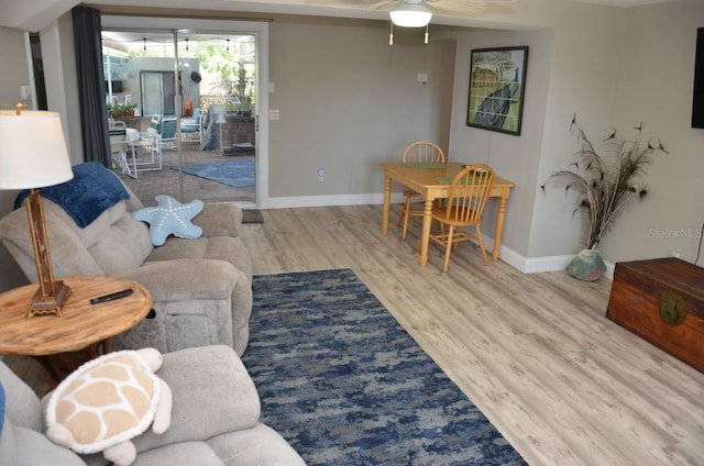 living room featuring light wood-type flooring and ceiling fan