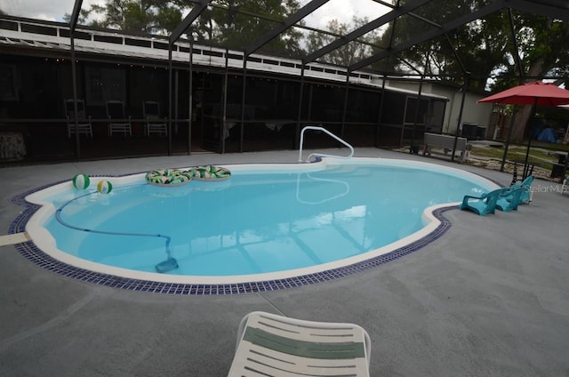 view of swimming pool with a patio and a lanai