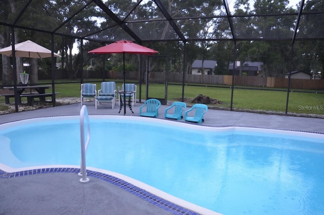 view of pool featuring a patio area, a lawn, and glass enclosure