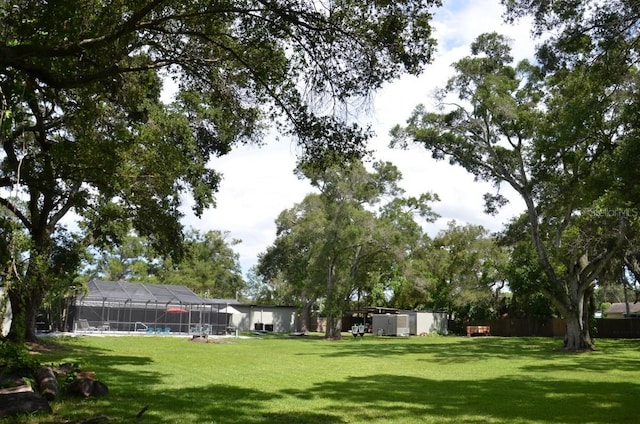 view of yard featuring a pool and a lanai