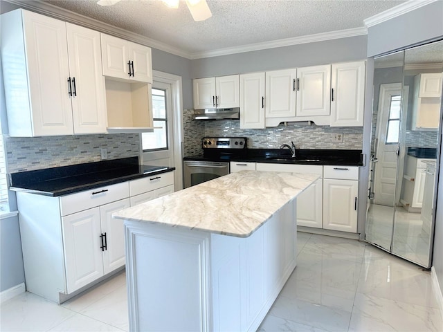 kitchen featuring light tile patterned flooring, stainless steel range with electric stovetop, a center island, and white cabinetry