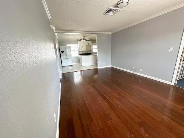 unfurnished living room featuring ceiling fan, wood-type flooring, a textured ceiling, and crown molding