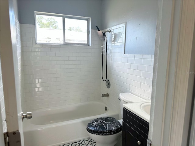 full bathroom featuring tile patterned floors, vanity, tiled shower / bath, and toilet