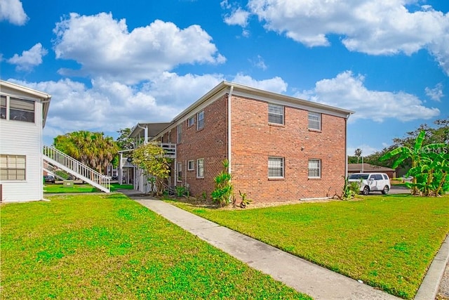 view of side of property with a lawn