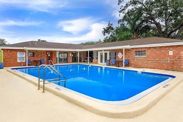 view of swimming pool featuring a patio