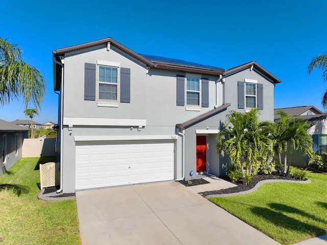 view of front of property with solar panels, a front yard, and a garage