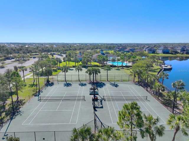 view of tennis court with a water view