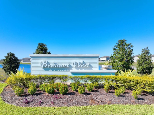 community / neighborhood sign featuring a water view