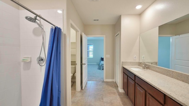 bathroom with tile patterned floors, vanity, toilet, and a shower with curtain