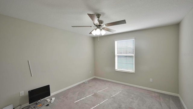 spare room with light carpet and a textured ceiling