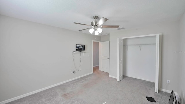 unfurnished bedroom with ceiling fan, a closet, and light colored carpet