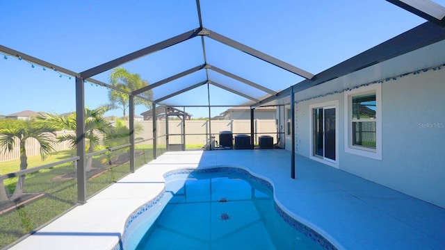 view of swimming pool with a lanai and a patio area