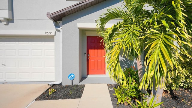 view of exterior entry featuring a garage